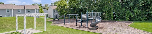 a park with a playground and a swing set