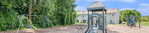 a playground with a swing set in a park