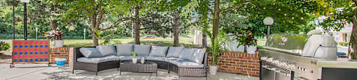 a backyard with a couch and a grill and a barbecue