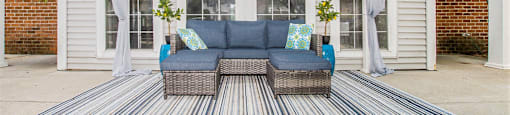 a living area with a couch and a table on a patio