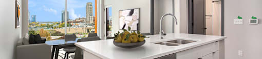 an open kitchen and living room with a view of the city