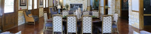 A large room with a fireplace and a chandelier.