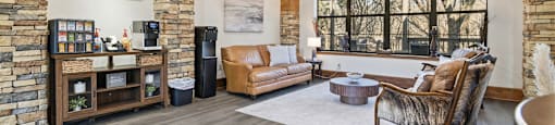 A living room with a stone wall and wood flooring.