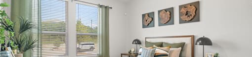 A bedroom with a bed, nightstand, and a ceiling fan.
