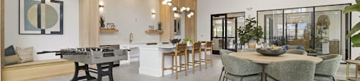 A modern dining room with a large table and chairs.
