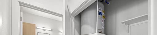 A kitchen with a refrigerator built into the wall.