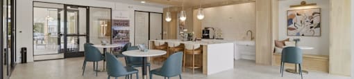 A modern kitchen and dining area with a large island and chairs.