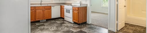 a kitchen with white appliances and wooden cabinets