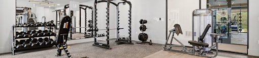 A spacious home gym with a variety of equipment.