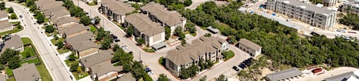 A bird's eye view of a residential area with houses and buildings.