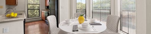 a dining room with a table and chairs and a kitchen