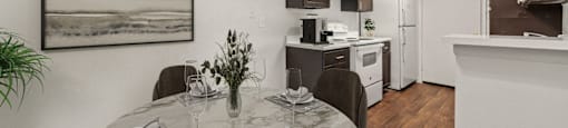a kitchen and dining room with a table and chairs