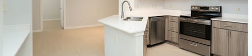 A kitchen with a white island and stainless steel appliances.