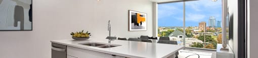 an open kitchen with an island and a view of the city