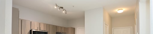 A kitchen with a sink and a refrigerator.