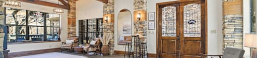 A large room with wooden floors and a stone wall.
