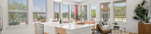 A kitchen with a white counter and wooden floors.