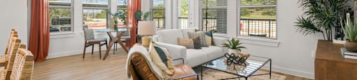 A living room with a chair, couch, and a table.
