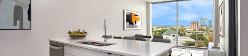 an open kitchen with an island and a view of the city