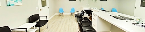 A conference room with black chairs and a white table.