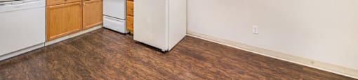 a kitchen with white appliances and wooden cabinets