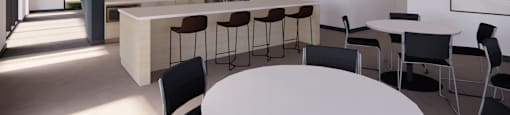 A modern kitchen with a bar area and dining table.