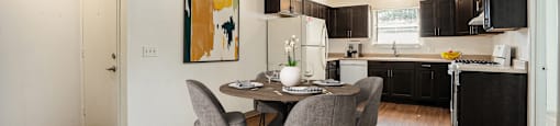 an open kitchen and dining room with a table and chairs