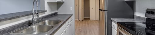 Apartment kitchen with a sink, stove, and refrigerator.