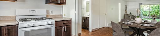 a kitchen with a stove and a dining table