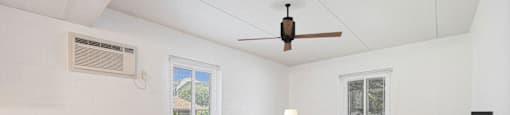 a living room with a couch and a ceiling fan