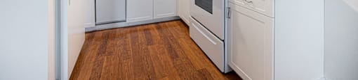 a kitchen with white appliances and white cabinets