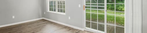 a bedroom with two windows and a door