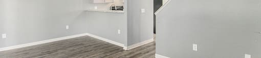 a bedroom with hardwood floors and grey walls