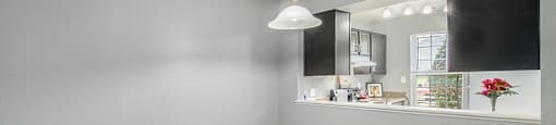 a bedroom with grey walls and a white pendant light hanging from the ceiling