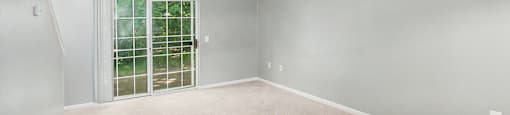 a bedroom with gray walls and white carpet