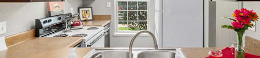 a kitchen with a sink and a refrigerator