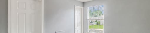 a bedroom with a door and a window