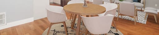a living room and dining room with a table and chairs