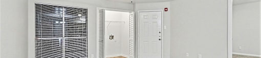 A room with a ceiling fan and wooden flooring.
