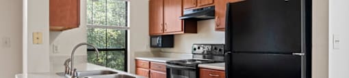 a kitchen with a white counter top and black appliances