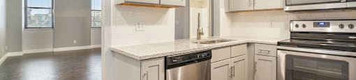 The Lofts Apartments In Grand Rapids, MI Marble Countertop Kitchen and Hardwood Floors