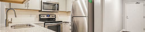 The Lofts Apartments In Grand Rapids, MI Marble Countertop Kitchen and Hardwood Floors