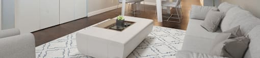 a living room with a white couch and a white coffee table