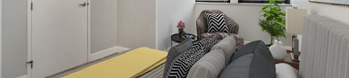a living room with a couch and two windows