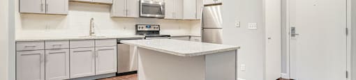 The Lofts Apartments In Grand Rapids, MI Marble Countertop Kitchen and Hardwood Floors
