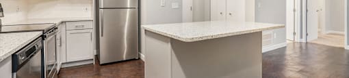 The Lofts Apartments In Grand Rapids, MI Marble Countertop Kitchen and Hardwood Floors