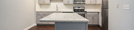 The Lofts Apartments In Grand Rapids, MI Marble Countertop Kitchen and Hardwood Floors