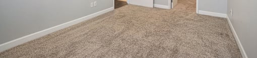 The Lofts Apartments in Grand Rapids, MI Open Concept Living Room with Hardwood Floors and Marble Countertop Kitchen