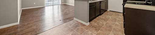 a kitchen and living room with a sliding glass door to a patio
