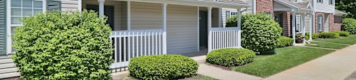 an apartment building with a sidewalk in front of it